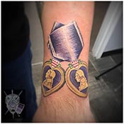 Two purple Heart Tattoos in color on wrist
