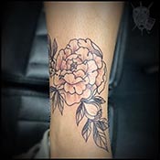 flower on ankle in black and grey tattoo